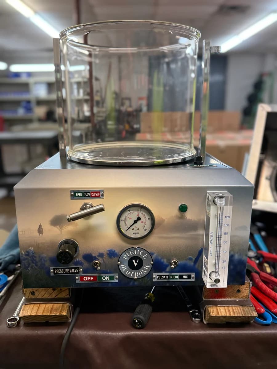 Embalming machine wrap — front panel showing Pierce Duotronic with bluebonnet landscape