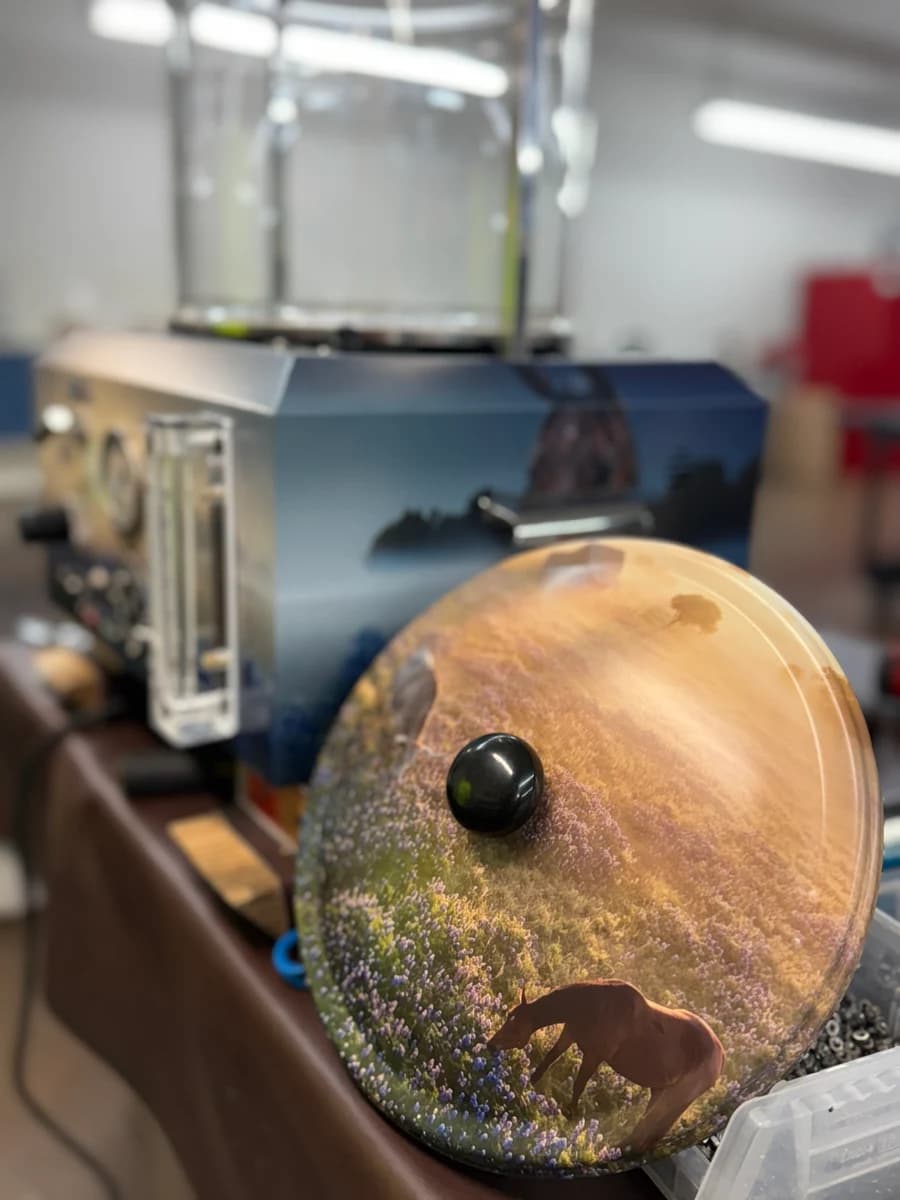 Embalming machine wrap — curved lid detail with Texas wildflower and longhorn design