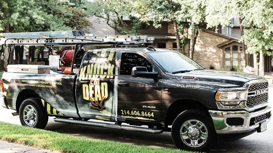 Knock Em Dead Pest Control's earlier truck, with the company name split across the window line and the services in small type on the bed