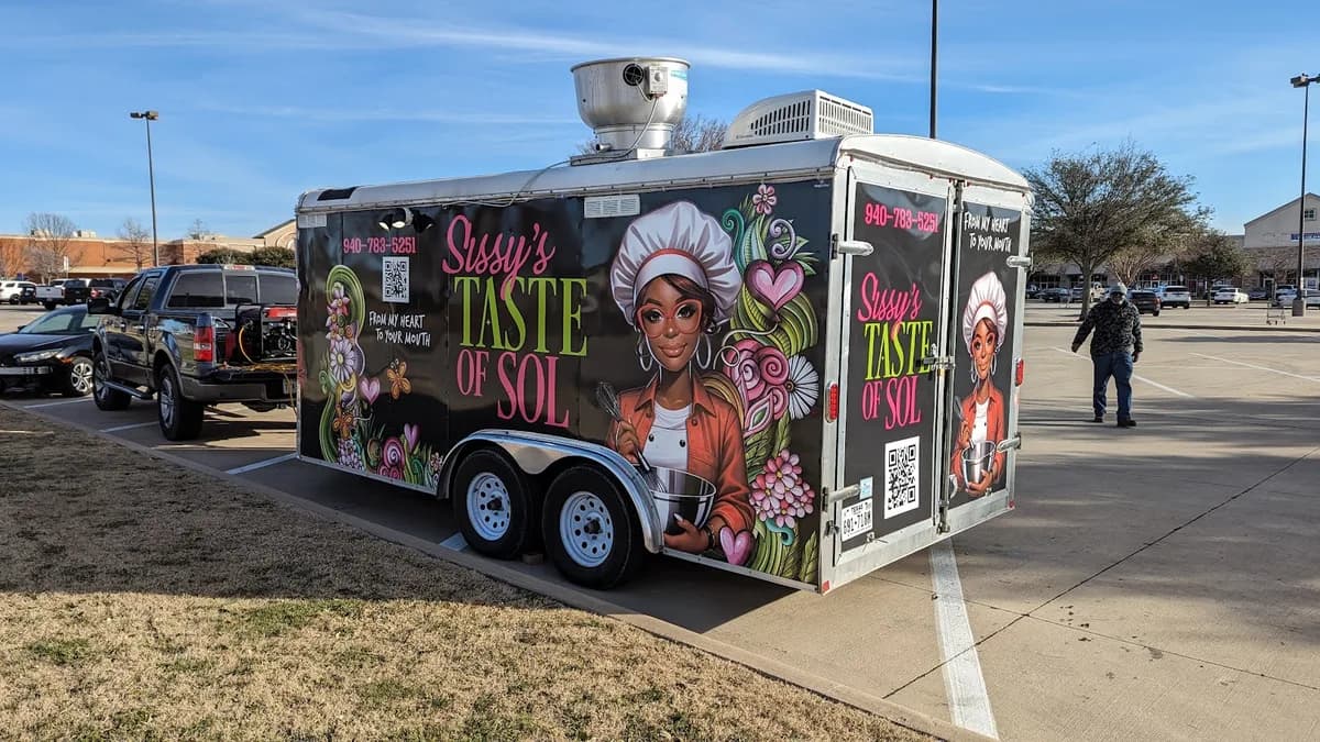 Rear view of the Sissy's Taste of Sol food trailer wrap, showing the full illustrated design