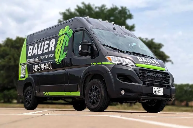 Black commercial van with lime green and white custom wrap