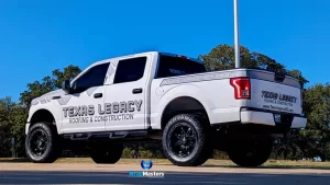 White Ford F-150 Raptor truck with custom 