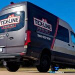 Black commercial van with red and white "TEX-LINE Roofing" custom wrap design parked outdoors under clear blue sky, with contact number displayed and a suburban backdrop